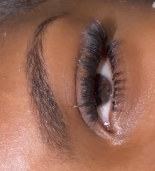 Close-up of a classic cluster lash set with bottom lashes applied